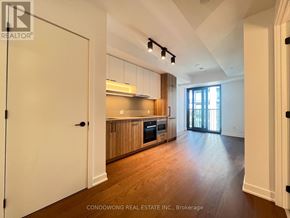 Toronto (Forest Hill South) condo for rent - A spacious kitchen with wooden cabinets and a large island.