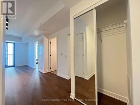 Toronto (Forest Hill South) condo for rent - A spacious room with wood flooring and white walls.
