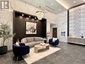 Toronto (Willowdale East) condo for rent - A realtor's office with a large couch and a painting on the wall.