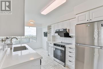 Toronto (Willowdale East) condo for rent - A kitchen with white cabinets and appliances.