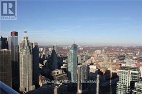 Toronto (Waterfront Communities) condo for rent - A cityscape with a clear sky and buildings of various heights.