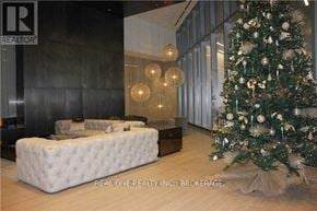 Toronto (Waterfront Communities) condo for rent - A Christmas tree is decorated in a living room.