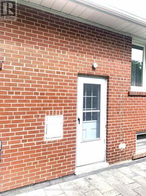 Toronto (Newtonbrook East) apartment for rent - A red brick house with a white door and windows.