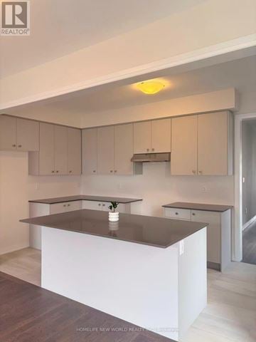 Pickering townhouse for rent - A modern kitchen with a large island in the center.