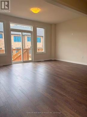 Pickering townhouse for rent - A room with wooden flooring and a sliding glass door leading to a balcony.