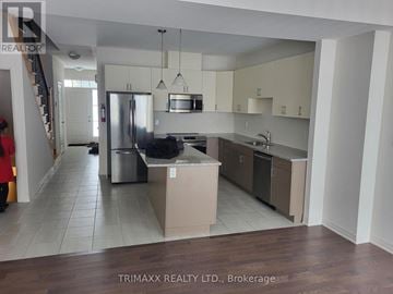 Zorra (Thamesford) townhouse for rent - A kitchen with a refrigerator, stove, and sink.