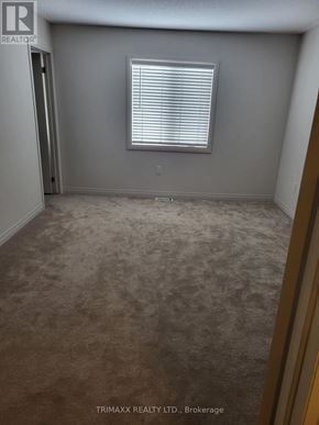 Zorra (Thamesford) townhouse for rent - A room with a carpeted floor and a window with blinds.