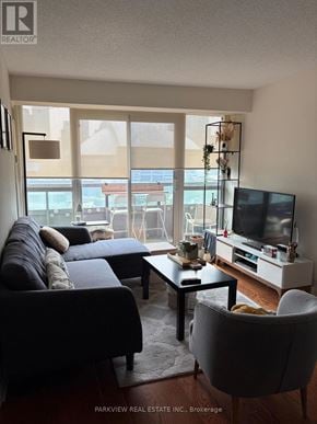 Toronto (Waterfront Communities) condo for rent - A living room with a couch, chair, and television.