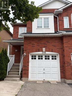 Mississauga (Meadowvale Village) apartment for rent - A red brick house with a white garage door and number 598 on it.