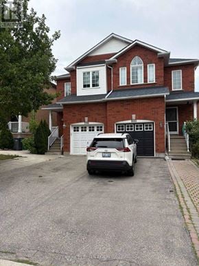 Mississauga (Meadowvale Village) apartment for rent - A white car is parked in front of a red brick house.
