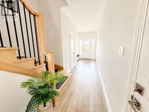 Welland (Coyle Creek) townhouse for rent - A long hallway with a plant on the left side.