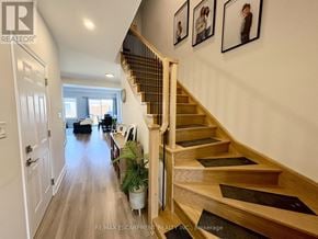 Welland (Coyle Creek) townhouse for rent - A hallway with a staircase and pictures on the wall.