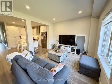Welland (Coyle Creek) townhouse for rent - A living room with a grey sofa and a television.