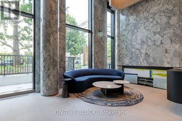 Toronto (Forest Hill South) condo for rent - A modern living room with a blue sofa and a round coffee table.