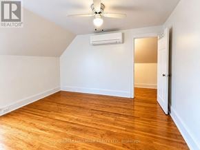 Toronto (Humewood-Cedarvale) triplex for rent - A room with a ceiling fan and wooden flooring.