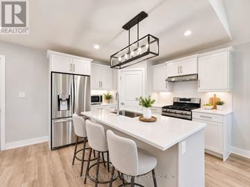 South Huron (Exeter) apartment for rent - A modern kitchen with white cabinets and a large island.