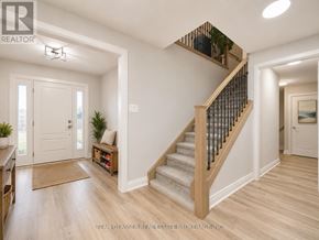 South Huron (Exeter) apartment for rent - A well-lit hallway with a staircase and a door.