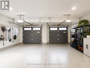 South Huron (Exeter) apartment for rent - A spacious garage with two doors and a wall of shelves on the right.