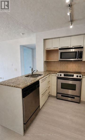 Toronto (Church-Yonge Corridor) condo for rent - A kitchen with a stove top oven and microwave.