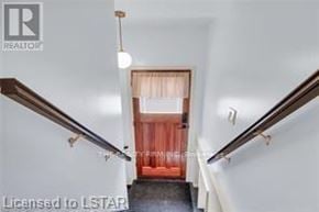 London South (South H) apartment for rent - A hallway with a wooden railing and a red curtain.
