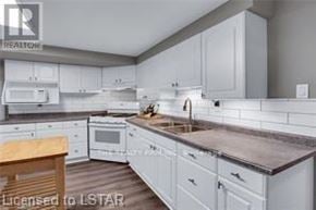 London South (South H) apartment for rent - A kitchen with white cabinets and a wooden table.