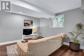London South (South H) apartment for rent - A living room with a beige couch and a small table with a lamp.