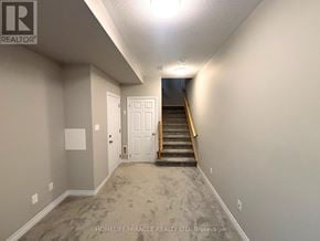 Brant (Paris) townhouse for rent - A hallway with a staircase leading to a door at the end.