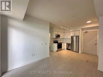 Toronto (Humber Heights) condo for rent - A spacious kitchen with white cabinets and stainless steel appliances.