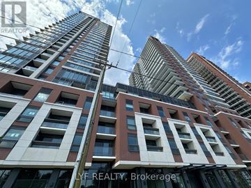 Toronto (Humber Heights) condo for rent - A tall building with a glass facade stands next to a shorter building with a brick facade.
