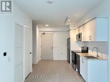 Toronto (Humber Heights) condo for rent - A kitchen with white cabinets and appliances in a real estate listing.