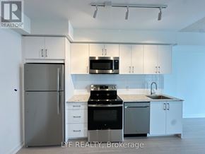 Toronto (Humber Heights) condo for rent - A kitchen with white cabinets and a stainless steel refrigerator.