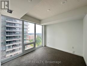 Toronto (Humber Heights) condo for rent - A room with a large window overlooking a building.