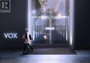 Toronto (Church-Yonge Corridor) condo for rent - A woman is walking towards a glass door with the word VOX on it.