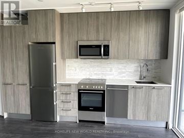 Toronto (Church-Yonge Corridor) condo for rent - A modern kitchen with a refrigerator, oven, and microwave.