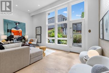 Toronto (Hillcrest Village) townhouse for rent - A modern living room with a large window and a painting on the wall.
