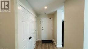 London condo for rent - A hallway with a white door on the left and a white door on the right.
