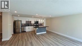 London condo for rent - A kitchen with a refrigerator, oven, and microwave.