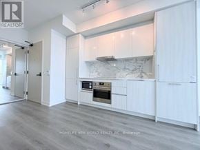 Vaughan (Vaughan Corporate Centre) condo for rent - A modern kitchen with white cabinets and a marble backsplash.