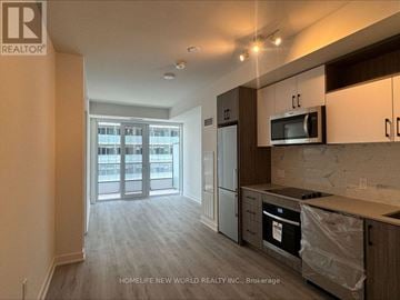 Toronto (Waterfront Communities) condo for rent - A kitchen with a microwave above the stove and a dishwasher to the right.