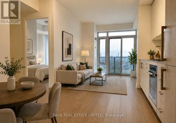Toronto (Waterfront Communities) condo for rent - A well-lit, modern living room with a dining table and chairs, and a kitchen area with stainless steel appliances.