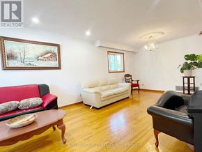 Toronto (L'amoreaux) apartment for rent - A living room with a red couch, a white couch, and a painting on the wall.