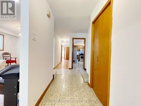 Toronto (L'amoreaux) apartment for rent - A hallway with a tiled floor and a wooden door.