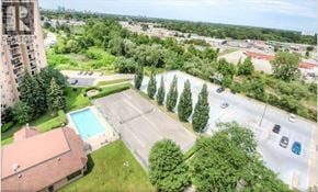 London condo for rent - A bird's eye view of a residential area with a swimming pool and a parking lot.