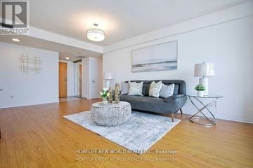 Toronto (Agincourt South-Malvern West) condo for rent - A living room with a grey couch, a glass coffee table, and a painting on the wall.