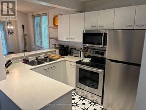 Blue Mountains townhouse for rent - A modern kitchen with a stainless steel refrigerator and oven.