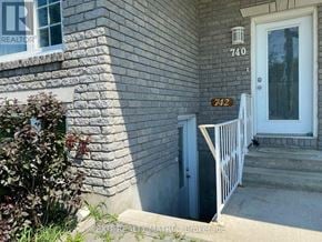 Casselman multi-family for rent - A house numbered 742 with a white door and a small garden.