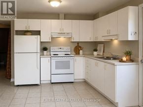 Casselman multi-family for rent - A white kitchen with EXIT REALTY MATRIX brokerage logo.