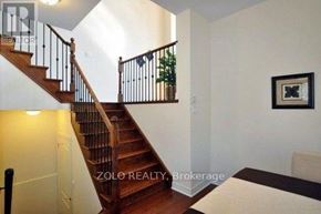 Newmarket (Stonehaven-Wyndham) house for rent - A staircase with a wooden handrail and a potted plant on the landing.