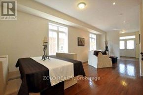 Newmarket (Stonehaven-Wyndham) house for rent - A bedroom with a bed, a chair, and a table.