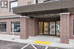 Tecumseh condo for rent - The entrance to a building with a sign that says REALTOR.